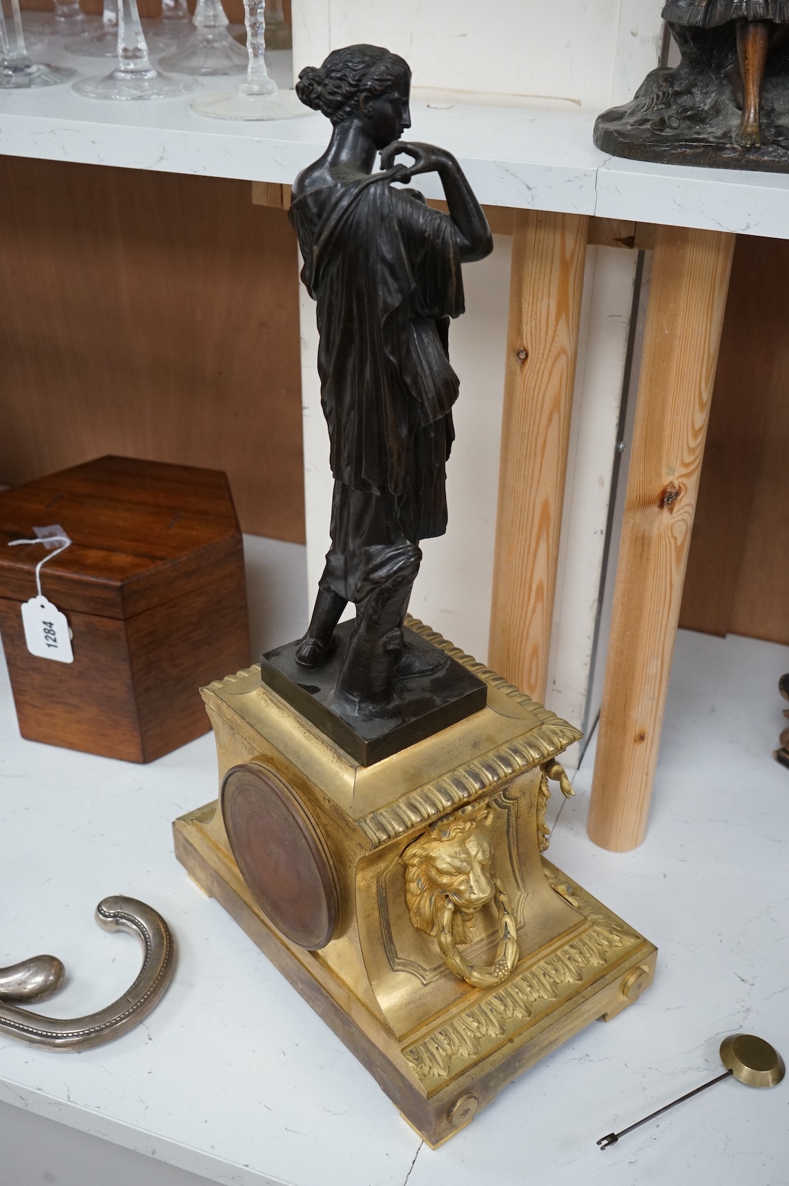 A 19th century French gilt bronze mantel clock, with classical figural surmount and floral painted dial, clock 54cm high.